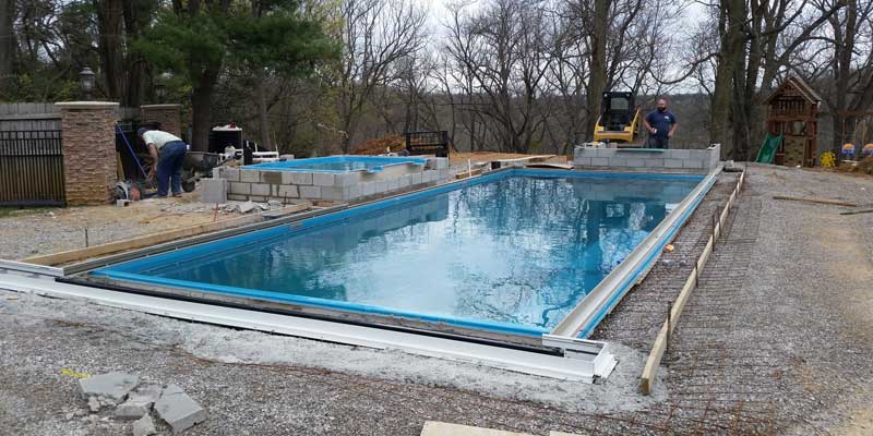 Pour concrete patio and construct any features